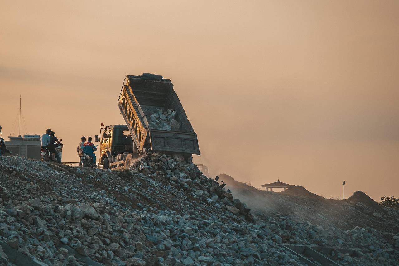 A dump truck operates at a landfill waste-disposal site.