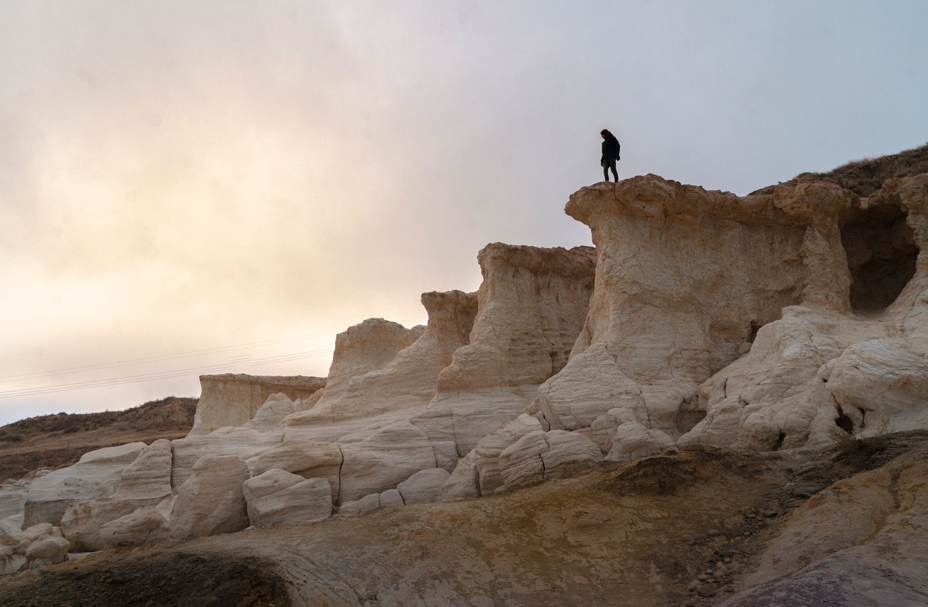 A visitor stands among the rock formations at Paint Mines Interpretive Park in Colorado.
