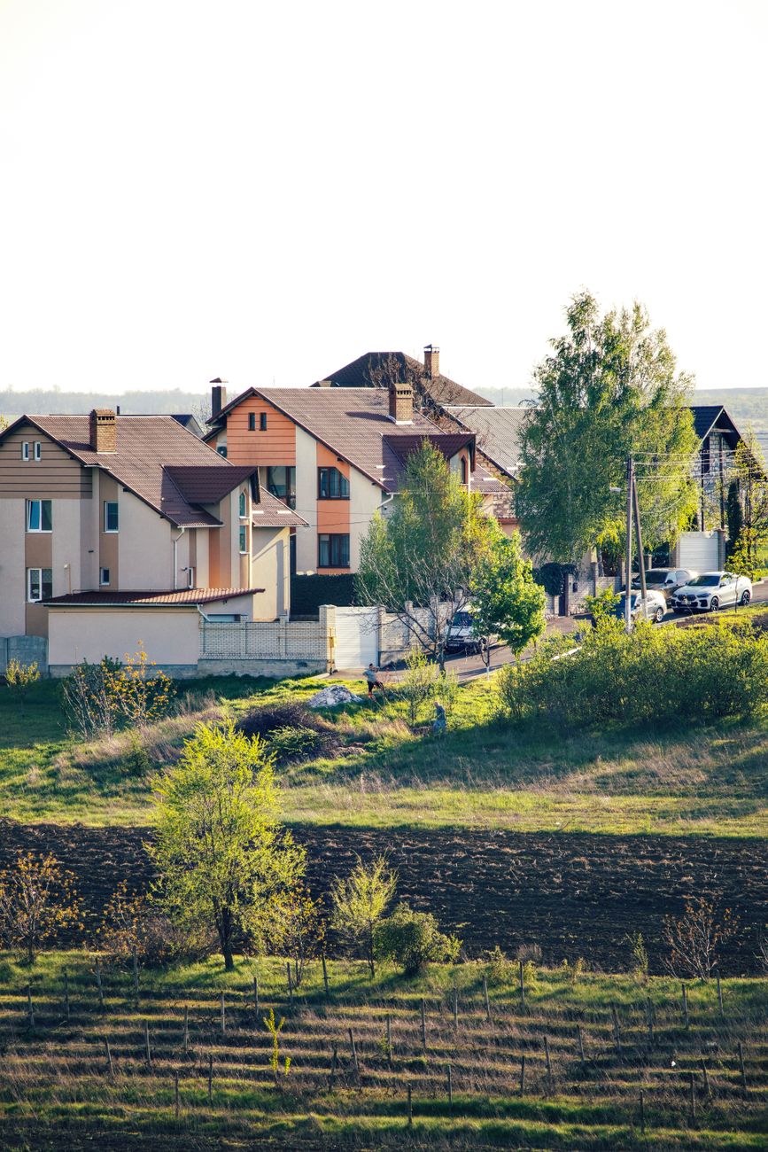 Homes stand beside open land.